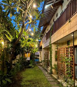 a courtyard of a building with trees and plants at Villa Puriartha Ubud - CHSE Certified in Ubud