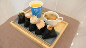 a tray of sushi and a cup of tea on a table at Toyoko Inn Tokyo Haneda Airport No.1 in Tokyo