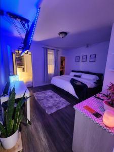 a purple bedroom with a bed and a table at Zen Oasis in Newark