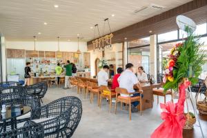 a group of people sitting at a restaurant at Apple House & Coffee in Ba Ria