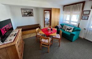 a living room with a table and a blue couch at B&B CHALET NICOLUSSI in Trento