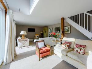 a living room with a couch and a staircase at 6 bed in Barnstaple 85615 in Tawstock
