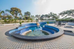 a swimming pool with blue water in a courtyard at CSR Landmark Resorts in Coimbatore