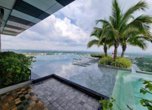 a swimming pool with a view of the water at luxury stay Monaco in Na Jomtien