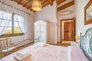 a bedroom with a bed and a window at Agriturismo Maramaldo in Castelfiorentino +102 photos