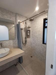 a bathroom with a shower and a sink at Sasima House in Chiang Mai