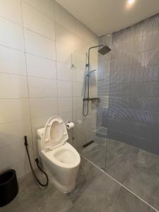 a bathroom with a toilet and a shower stall at lovelytheroom in Ko Lanta