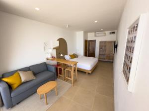 a living room with a couch and a bed at lovelytheroom in Ko Lanta