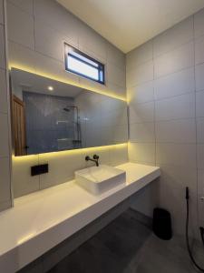a white bathroom with a sink and a mirror at lovelytheroom in Ko Lanta