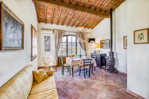 a living room with a table and chairs at Agriturismo Maramaldo - Happy Rentals in Castelfiorentino