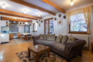 a living room with a couch and a table at Pension Iveta in Liptovský Mikuláš