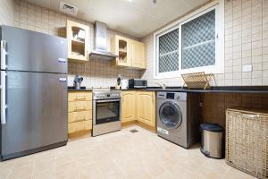 a kitchen with a stainless steel refrigerator and a dishwasher at HomesGetaway - Stylish 1BR Armada Cluster P in Dubai