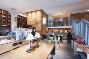 a lobby of a store with people sitting at Hotel Relief Kokura Annex in Kitakyushu