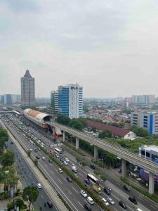 a busy highway with traffic in a city with buildings at Apt Signature Park Studio H3r1 w/ Wi-Fi & Netflix in Jakarta