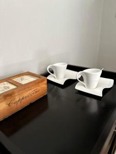 two tea cups and a box on a table at The Hempel Guesthouse in Mokopane