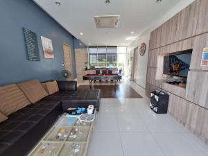 a living room with a couch and a table at บีชทาวน์ ชะอำ พูลวิลล่า ห่างหาดชะอำ2กม Beach town cha-am poolvilla from Cha-Am beach just 2km in Cha Am