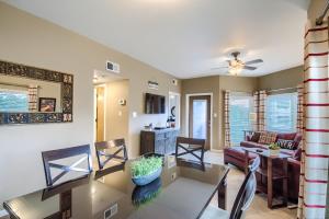 a dining room and living room with a table and chairs at IC 209 Comal Escape in New Braunfels