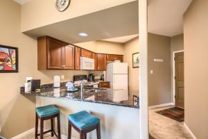 a kitchen with a counter and two stools at IC 209 Comal Escape in New Braunfels