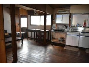 a large kitchen with a wooden floor in a room at Tsukubo-gun - House / Vacation STAY 34603 in Hayashima