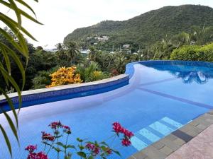 a swimming pool with a view of a mountain at Villa Ashiana - Beautiful 3-bedroom villa in Marigot Bay villa in Marigot Bay