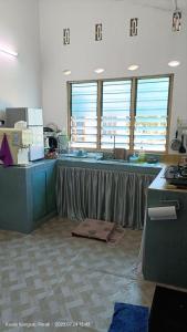 a kitchen with a sink and a counter top at Homestay Laman Dahlia in Kuala Kangsar