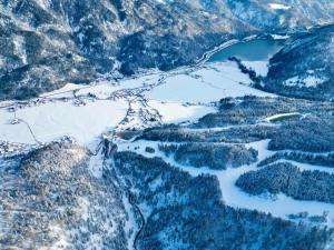 an aerial view of a snowy mountain valley with a lake at loisi's Boutiquehotel in Achenkirch
