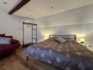 a bedroom with a large bed and a red couch at Ferienwohnungen Zum Neuhäusel in Quedlinburg