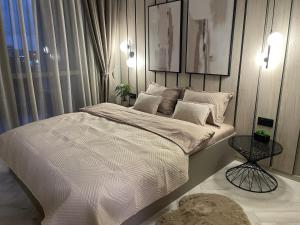a bedroom with a large bed with white sheets at Kristin`s Home in Burgas
