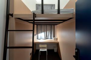 a room with a bunk bed and a desk and a chair at Sifang Space Hostel Xi'an - Xi'an KEJIDAXUE metro Line4 in Xi'an