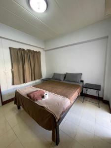 a bedroom with a large bed in a room at JJ Guesthouse in Chiang Mai