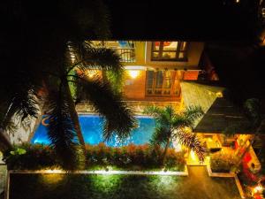 a view of a swimming pool at night at Raichak 3BHK 28ft pool Villa in Raichak