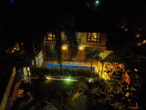 an overhead view of a swimming pool at night at Raichak 3BHK 28ft pool Villa in Raichak