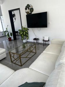 salon z białą kanapą i szklanym stołem w obiekcie VILLA NAYELI Luxury and Simplicity w mieście Órgãos