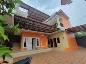 a rendering of a house with a solar roof at SPOT ON 93350 Alnasya Syariah in Palembang