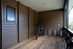 a bike parked in a room with a wooden floor at Haka House Aoraki Mt Cook in Mount Cook Village