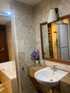 a bathroom with a sink and a mirror at Villa Dalam Laut 538 in Pantai Cenang