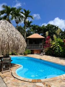 a swimming pool with a gazebo and a resort at Habitation Bonneville Chalet et Loft d'exceptions in La Trinité