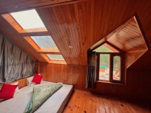 a bedroom with two beds in a room with a window at Hotel Anupam in Kasol