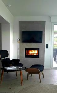 a living room with a fire in the fireplace at Villa Mare in Makri
