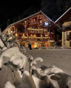 a building covered in snow with sheep in front of it at Wongade in Gressoney-la-Trinité