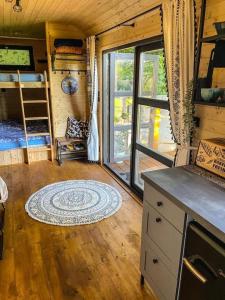 a living room with a large window in a tiny house at Maringotka Trojzemka in Hrádek nad Nisou