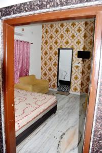 a living room with a bed and a mirror at Ramaya Home Stay in Varanasi