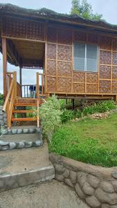 a house with a porch and stairs to it at LOONY CAFE in Loon