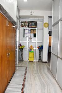 a hallway with two vases with flowers in it at Ramaya Home Stay in Varanasi