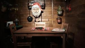 a table with a santa claus head on the wall at Trullo Mauro MGG - Trullo Fragale in Martina Franca