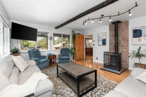 a living room with a white couch and a fireplace at Views, Hot Tub, Outdoor Shower, 15m from Sequoia in Three Rivers