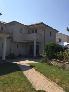 a large white house with a pathway in front of it at Apartment Casa Eni in Dražice