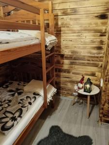 a room with two bunk beds and a table at Chalúpka Anit 