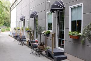 a row of tables and chairs on the side of a building at Amical Hotel in Wuppertal