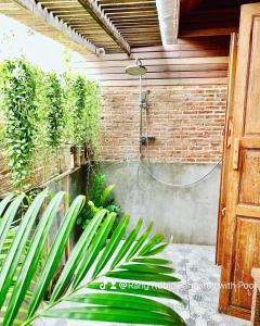 a bathroom with a shower and some plants at Rang Robin Farmstay for 4 with pool in Ban Wang Muang
